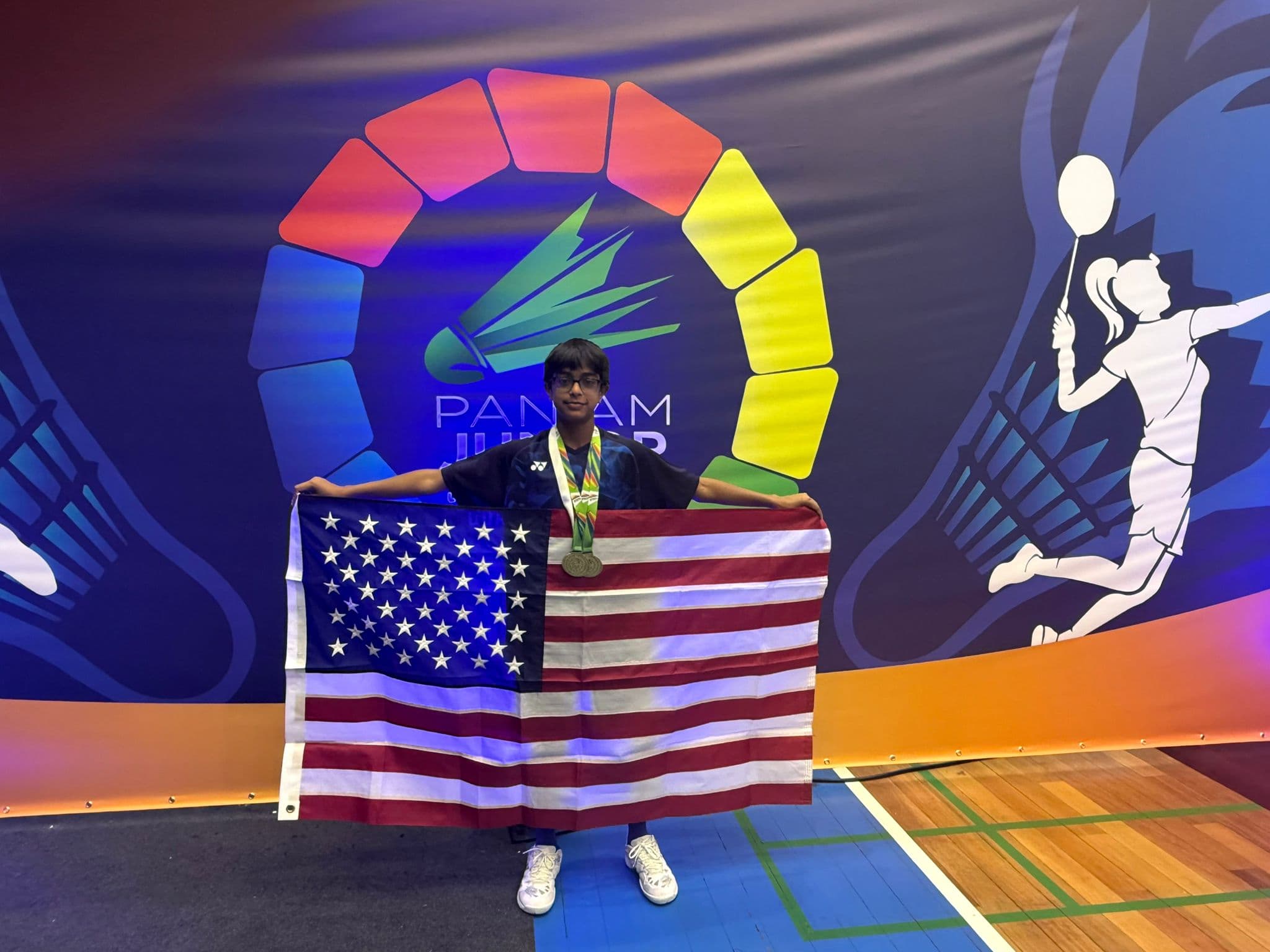 Varish Karri holding the American flag with medals at the XXXIII YONEX Pan Am Junior Championships in Guatemala City